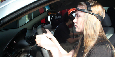 A Cardinal Newman School student experiences drunk driving on a simulator.