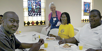 Vittoria Rocca, center, serves lunch to diners at Father Pat’s Lunch Kitchen at Precious Blood of Christ Church hall on Pawleys Island May 8. An estimated 20,000 meals have been served since it began in 2007. (Miscellany/Deirdre C. Mays)
