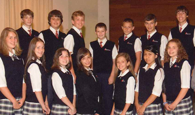 Prince of Peace School’s eighth-grade class, shown here before one of the students moved, is the first to graduate since the school opened in 2002.