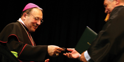 Bishop Robert E. Guglielmone hands out awards during the St. Leo University commencement May 15. (Miscellany/Christina Lee Knauss)