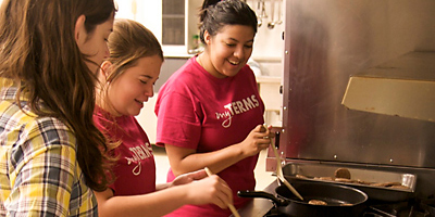 Maggie Mayeaux, Annie Arneman and Lorena Robles prepare breakfast for their mothers at a weekend retreat for girls at Precious Blood of Christ Church on Pawleys Island. (Miscellany/Deirdre C. Mays)