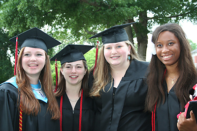 Cardinal Newman graduates Lauren Woodrum, Kimberly M. Mason, April Hammond and California Torry smile after receiving their diplomas May 29.
