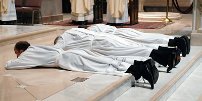 Deacons Artur Przywara, Richard Jackson and Philip Gillespie lie prostrate during their ordination to the diaconate in May 2009. The three men will be ordained priests at the Cathedral of St. John the Baptist in Charleston on June 11. (Miscellany/Douglas Deas)