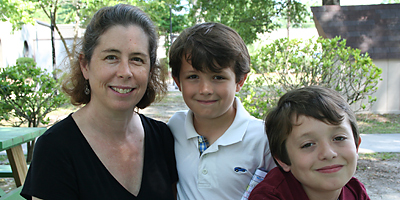 Laura Norton, a member of St. Michael Church in Garden City, founded MercyWorks to help parents and children learn about social justice while working together for people in need. She is pictured outside St. Michael with two of her six children, Matthew and Aaron Norton-Baker, all of whom participate. (Miscellany/Christina Lee Knauss)