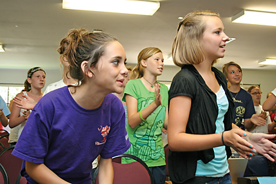 Students dance and clap to a song about God’s love at a praise and worship session during the Christian Leadership Institute for junior high students at Camp Kinard. (Miscellany/Christina Lee Knauss)