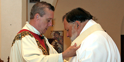 Father Richard D. Harris, diocesan vicar general and pastor of St. Joseph Church in Columbia, invests Deacon Malcolm J. Skipper Sr. with a stole during his ordination to the permanent diaconate. (Miscellany/Christina Lee Knauss)