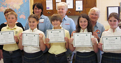 St. Joseph School students, from left, Matthew Kahler, Gabriella Waters, William Schenk, Andrea Rendino and Lacy DeSimone have earned their Anderson County Junior Master Gardener certification by completing two years of study and a gardening service project. Others in the photo were not identified. (Photo provided)