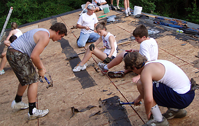 Teens work on the roof of a Johns Island house in the summer heat during a Home Works blitz July 19-24. (Photo provided)