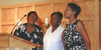 Participants sing at the “Women Celebrating Women” day in the new hall Aug. 15. More than 150 women attended. (Provided)