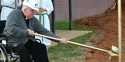 Father Robert H. Fix, former pastor of Our Lady of the Hills Church in Columbia, throws a shovelful of dirt on the future site of the parish’s classroom building. (Miscellany/Christina Lee Knauss)
