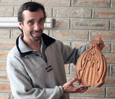 Sebastien Lepoutre holds a sculpture that was handcrafted by artisans in Cumbayá, Ecuador. The Bishop England High School graduate founded Hands on Earth, a fair-trade company that sells Ecuadorian goods to aid poor communities.