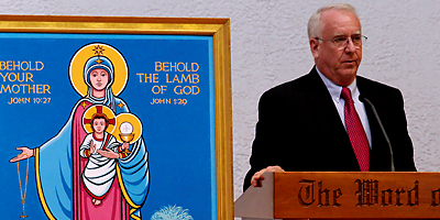 (Courtesy/Aaron Joseph) Steve Wood, founder of the St. Joseph Covenant Keepers, stands next to the icon of Our Lady of South Carolina during his talk at the eighth annual Diocesan Rosary Celebration held in Hilton Head Oct. 10.