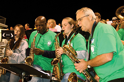 (Miscellany/Deirdre C. Mays) Carlos Ellis, second from left, and other members of Bishop England High School’s marching band alumni perform at the homecoming football game Oct. 22.