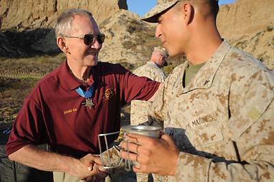 (Sgt. Scott M. Biscuiti/US Marine Corps) Retired Maj. Gen. James E. Livingston greets a member of Company E, 2nd Battalion, 4th Marine Regiment, at Camp Pendleton, Calif., July 16, 2009. Livingston served as the company’s commander in 1968 during the Vietnam War, where he earned the Medal of Honor and other decorations for heroic actions in combat.