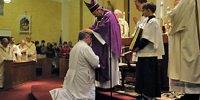 (Miscellany/Paul Brown) Bishop Robert E. Guglielmone blesses Deacon Ballard during the ordination ceremony held at Our Lady of the Rosary in Greenville.