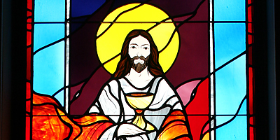 (Diocesan Archives) Christ shares His body and blood in a detail from this stained glass window at Our Lady Star of the Sea Church in North Myrtle Beach. The parish began an outreach program to help people with food and other necessities.