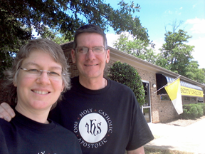 Stephanie Tuxford and Kip McIntyre pose in front of their bookstore