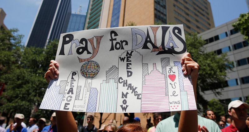 CNS/Erik Lesser, EPA: A sign is displayed during an interfaith prayer vigil in Thanksgiving Square in Dallas July 8. The prior evening a gunman shot and killed five police officers and wounded seven during a peaceful protest in downtown Dallas. The protest was in reaction to two black men being fatally shot by police officers in Baton Rouge, La., and a suburb of St. Paul, Minn.